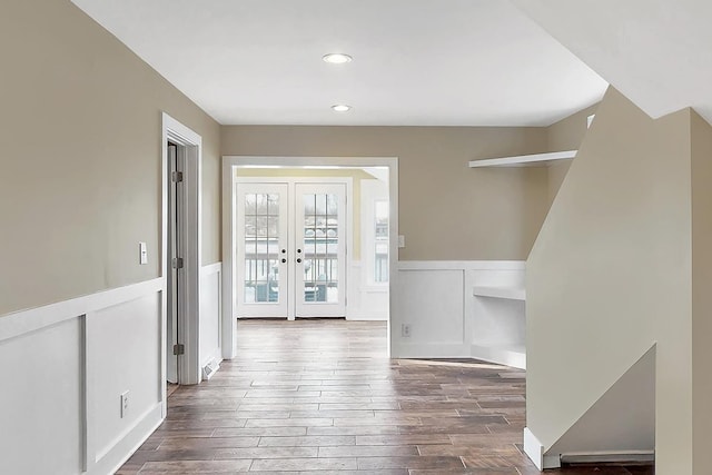 interior space featuring recessed lighting, dark wood finished floors, wainscoting, and french doors