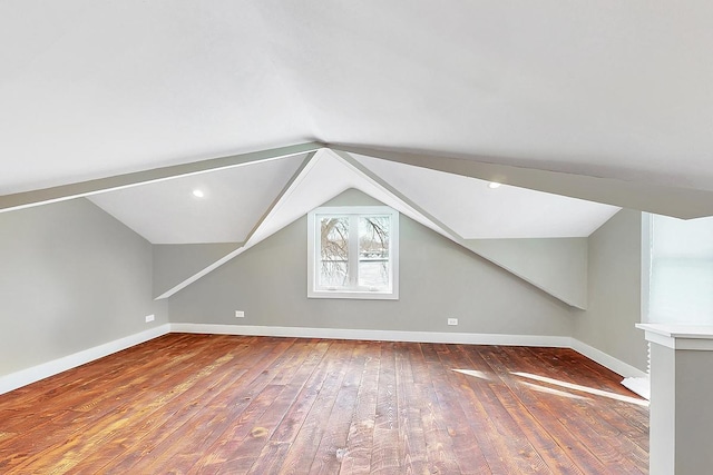 bonus room featuring wood-type flooring, lofted ceiling, and baseboards