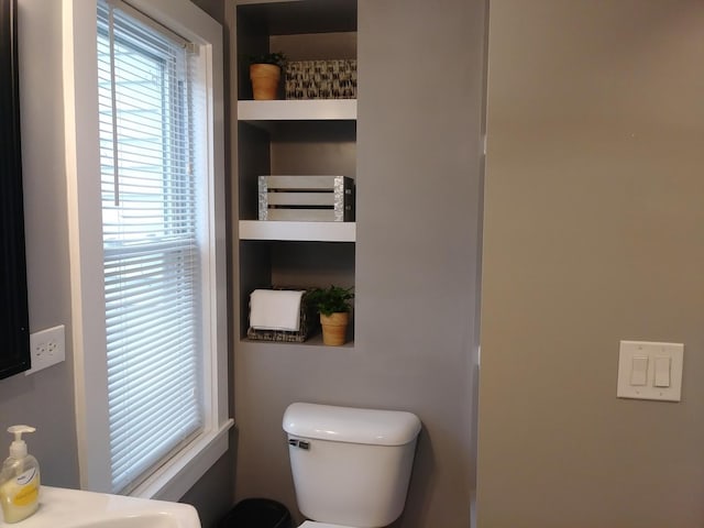 bathroom featuring plenty of natural light and toilet