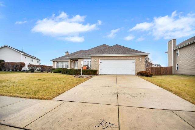 ranch-style house featuring a front lawn and a garage