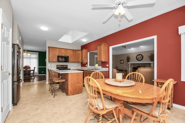 dining room featuring ceiling fan and sink