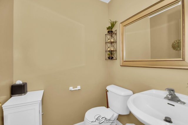 bathroom featuring sink and toilet