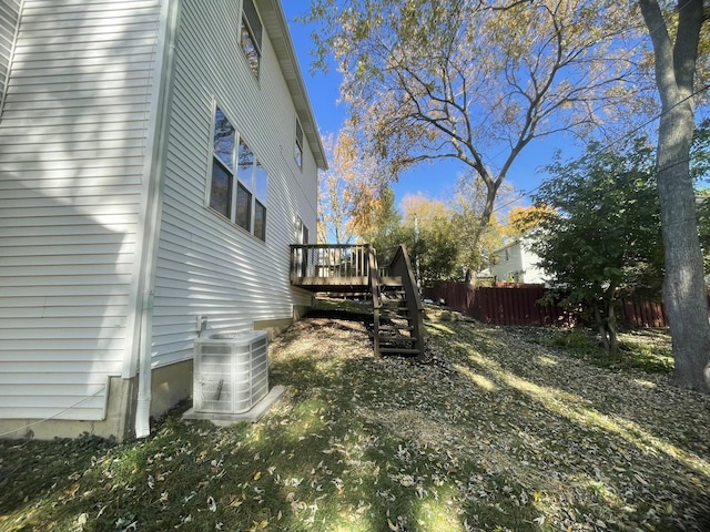 view of yard featuring a deck and central AC unit