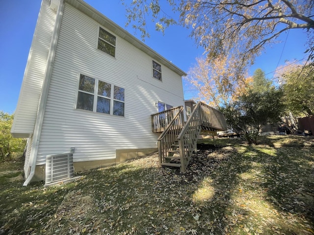 back of property with cooling unit and a wooden deck