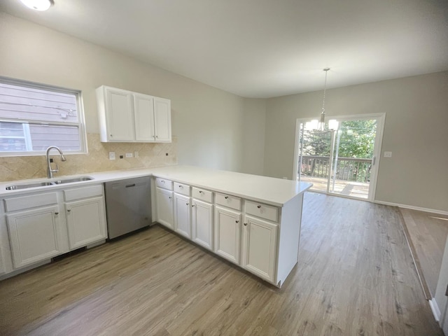 kitchen featuring white cabinetry, dishwasher, sink, kitchen peninsula, and light hardwood / wood-style floors