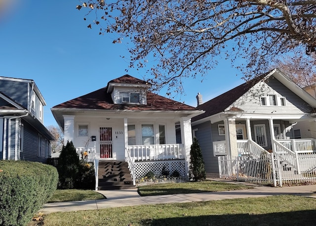 bungalow-style home with a porch and a front yard