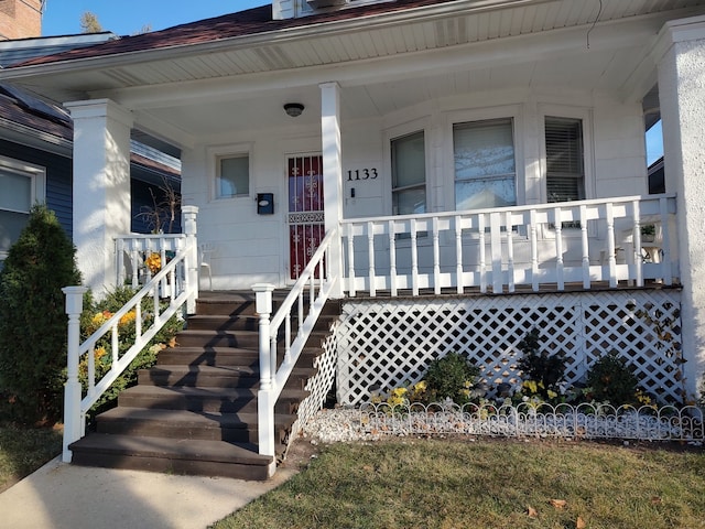 view of exterior entry featuring a porch