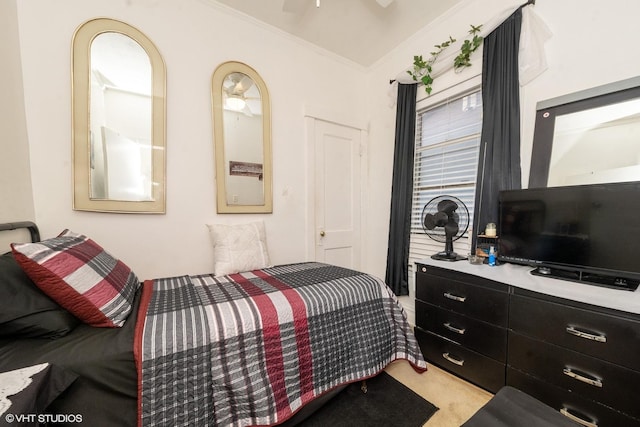 carpeted bedroom with ceiling fan and ornamental molding