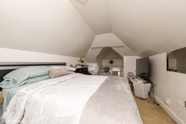 bedroom with an AC wall unit, light carpet, and vaulted ceiling