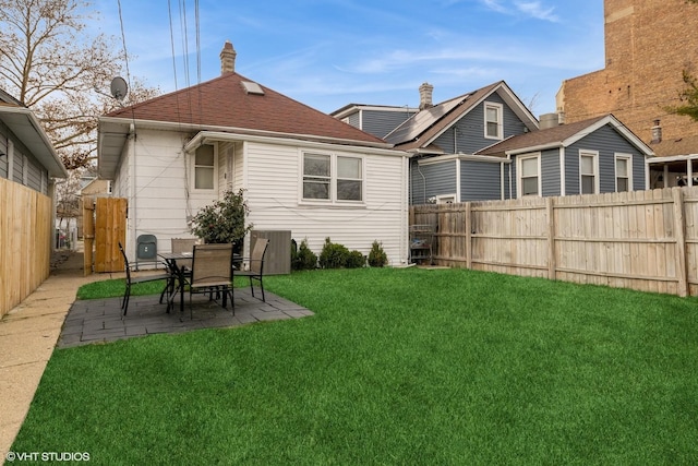 back of house featuring a yard, a patio, and central air condition unit