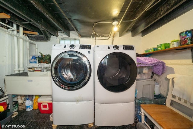 laundry area with sink and washing machine and clothes dryer