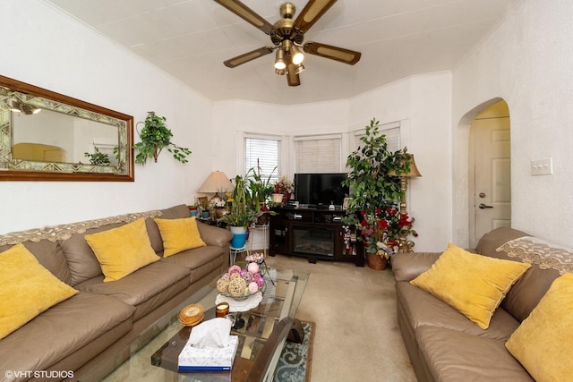 carpeted living room featuring ceiling fan and ornamental molding