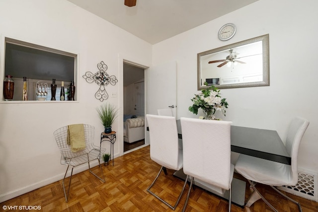 dining area featuring parquet floors and ceiling fan