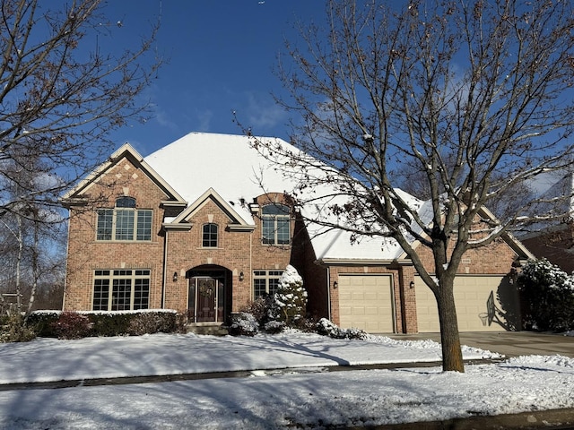 view of front of property featuring a garage and brick siding