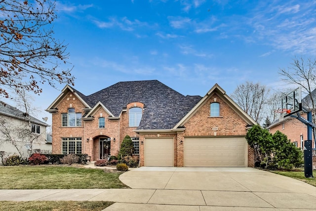 view of front facade with a front lawn, concrete driveway, and brick siding