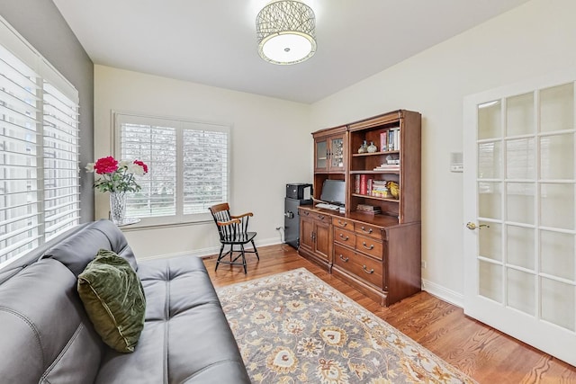 office space featuring baseboards and wood finished floors