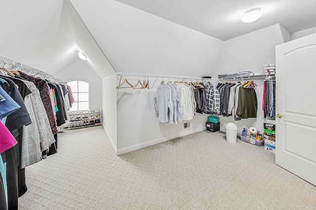 walk in closet featuring lofted ceiling, carpet, and visible vents