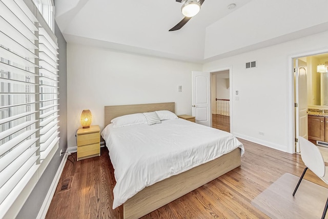 bedroom with baseboards, visible vents, ceiling fan, and wood finished floors