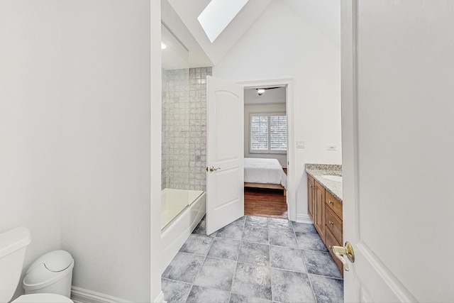 ensuite bathroom with vaulted ceiling with skylight, shower / tub combination, toilet, vanity, and ensuite bath