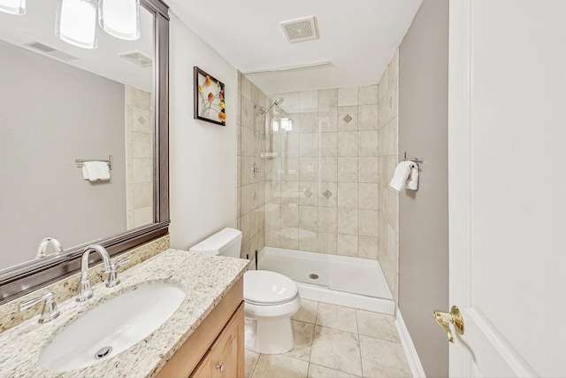 full bathroom featuring visible vents, tiled shower, vanity, and toilet