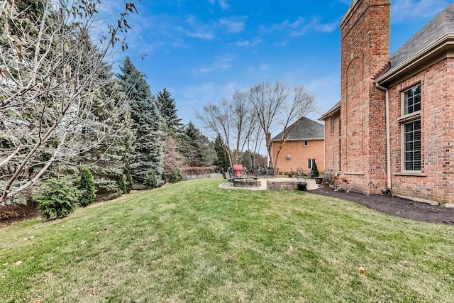 view of yard with a fire pit and a patio area