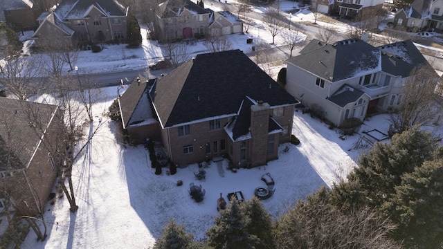 snowy aerial view featuring a residential view