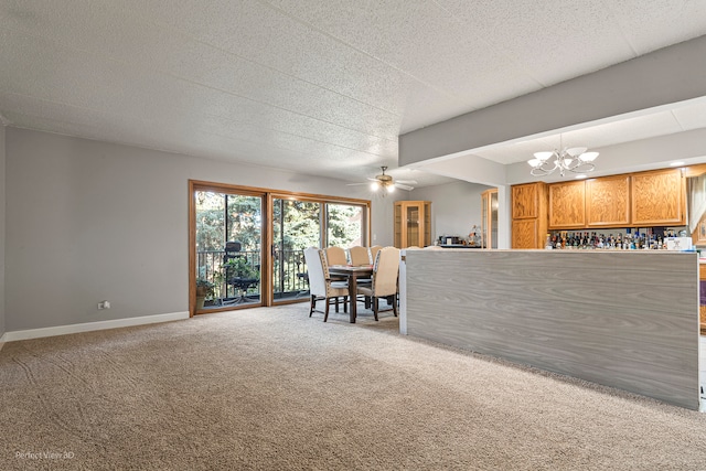 unfurnished living room with carpet flooring and ceiling fan with notable chandelier