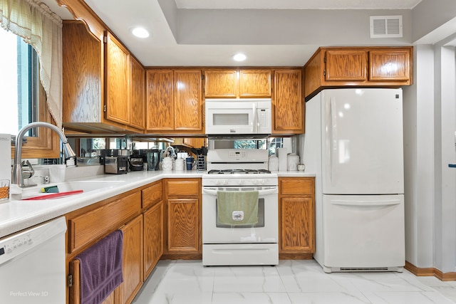 kitchen featuring white appliances and sink