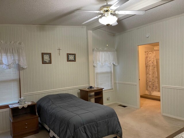 carpeted bedroom featuring vaulted ceiling, ensuite bath, ceiling fan, and a textured ceiling