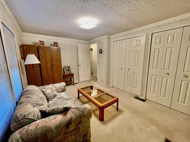 carpeted living room featuring crown molding and a textured ceiling