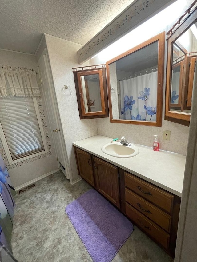 bathroom featuring vanity and a textured ceiling