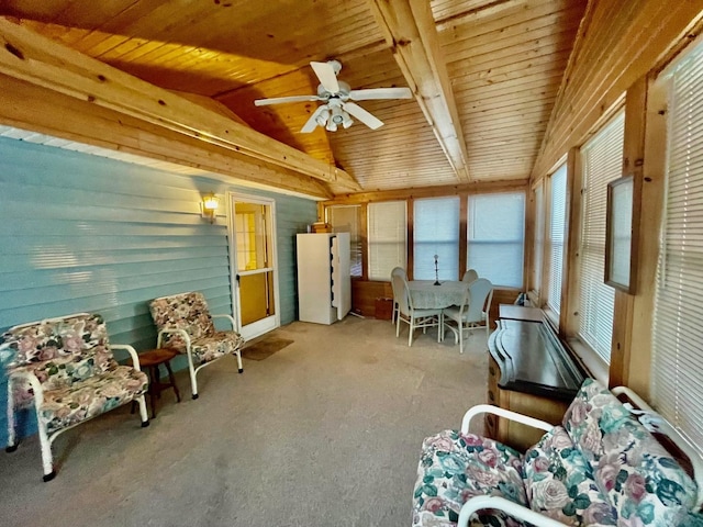 sitting room featuring vaulted ceiling with beams, ceiling fan, light colored carpet, and wood ceiling