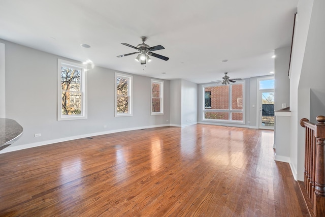 unfurnished living room with hardwood / wood-style flooring and ceiling fan