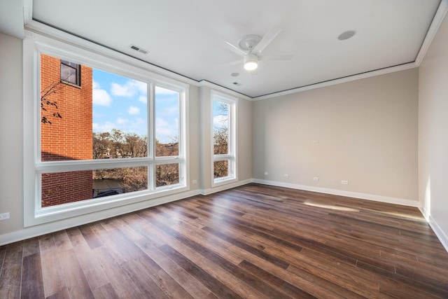 spare room with ornamental molding, ceiling fan, and dark wood-type flooring