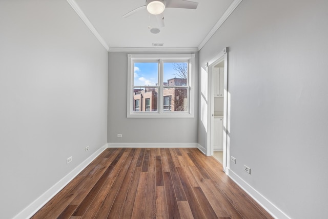 unfurnished room featuring ceiling fan, dark hardwood / wood-style flooring, and ornamental molding