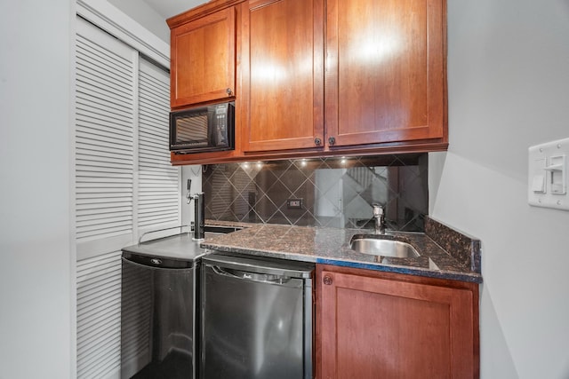 kitchen with stainless steel dishwasher, backsplash, sink, and dark stone counters