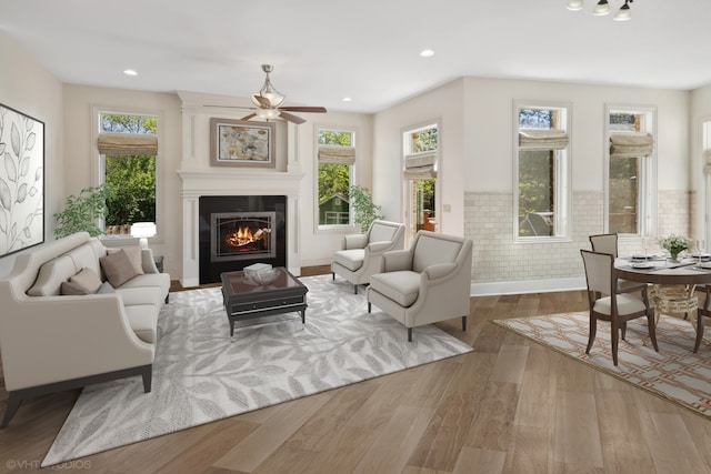 interior space featuring a large fireplace, plenty of natural light, and hardwood / wood-style flooring