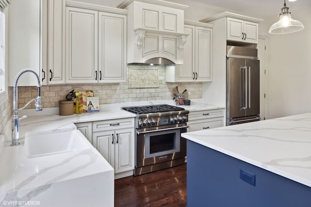 kitchen with hanging light fixtures, light stone countertops, dark hardwood / wood-style floors, and high end appliances