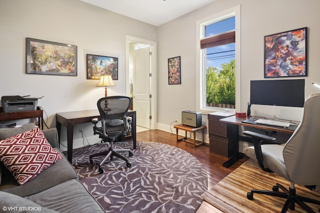 office space with dark wood-type flooring