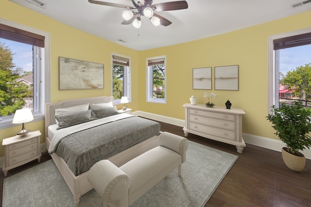 bedroom with ceiling fan and dark hardwood / wood-style flooring