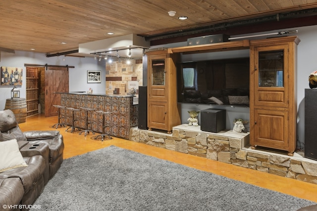 living room with a barn door, wood ceiling, and bar