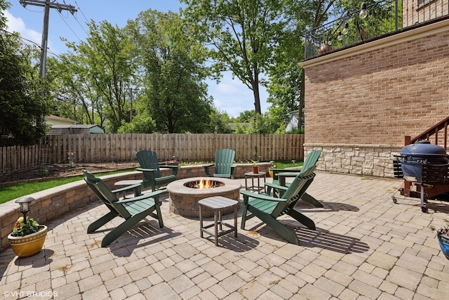 view of patio with a grill and a fire pit