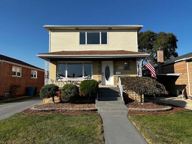 front of property featuring a porch and a front lawn