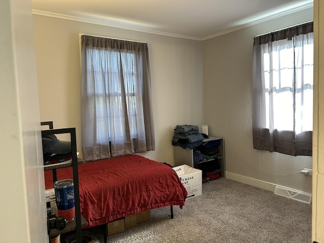 carpeted bedroom featuring multiple windows and ornamental molding