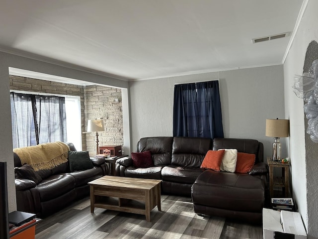 living room featuring dark hardwood / wood-style flooring and ornamental molding