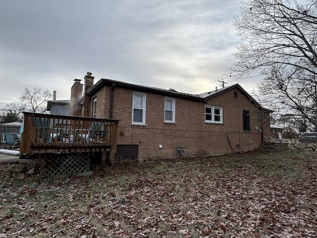 back of property featuring a wooden deck