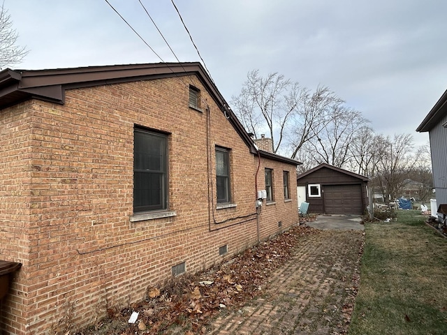 view of side of property featuring an outbuilding and a garage