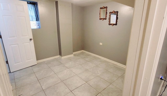 laundry area with light tile patterned flooring