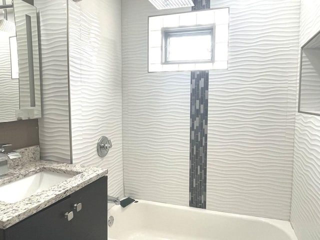 bathroom with vanity and tiled shower / bath combo