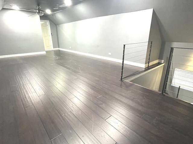 unfurnished room featuring ceiling fan, dark hardwood / wood-style flooring, and lofted ceiling